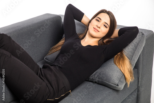 Portrait of a girl relaxing and smile on a sofa on white background photo
