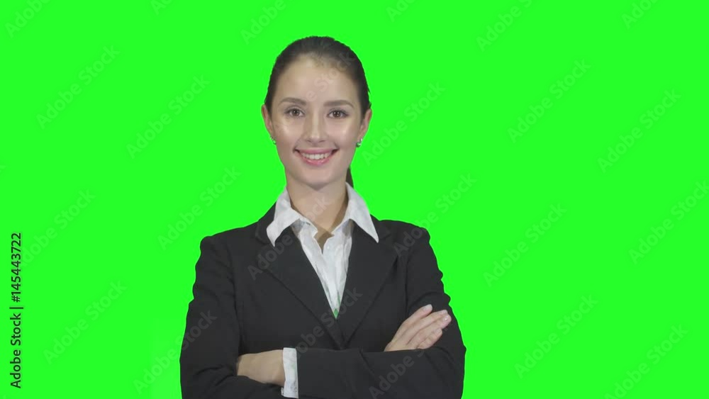beautiful business woman smiling and looking at camera on a green background beautiful business woman smiling and looking at camera on a green background