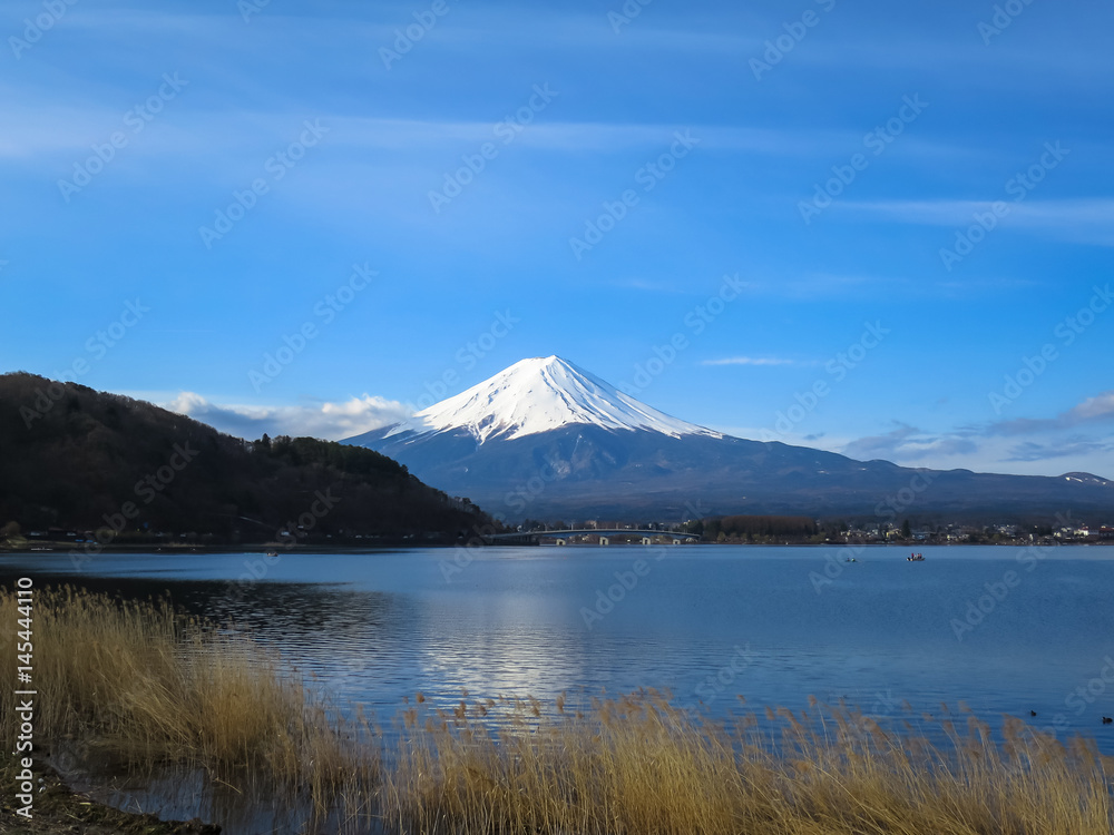 View of Fuji mountain with white snow top, kawaguchiko lake activities and blue sky background