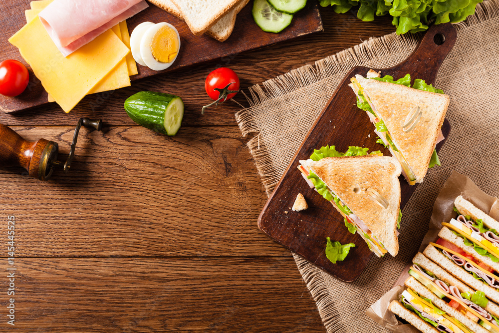 Delicious toast sandwich with ham, cheese, egg and vegetables. Delicious toast sandwich with ham, cheese, egg and vegetables.