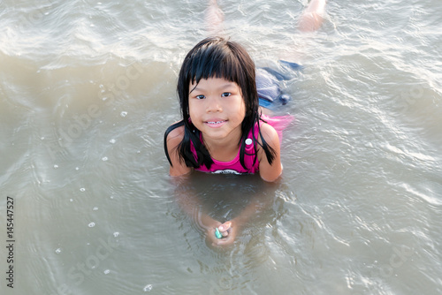 asian cute kid smile / asian kid smie and play at the beach © lovemelovemypic