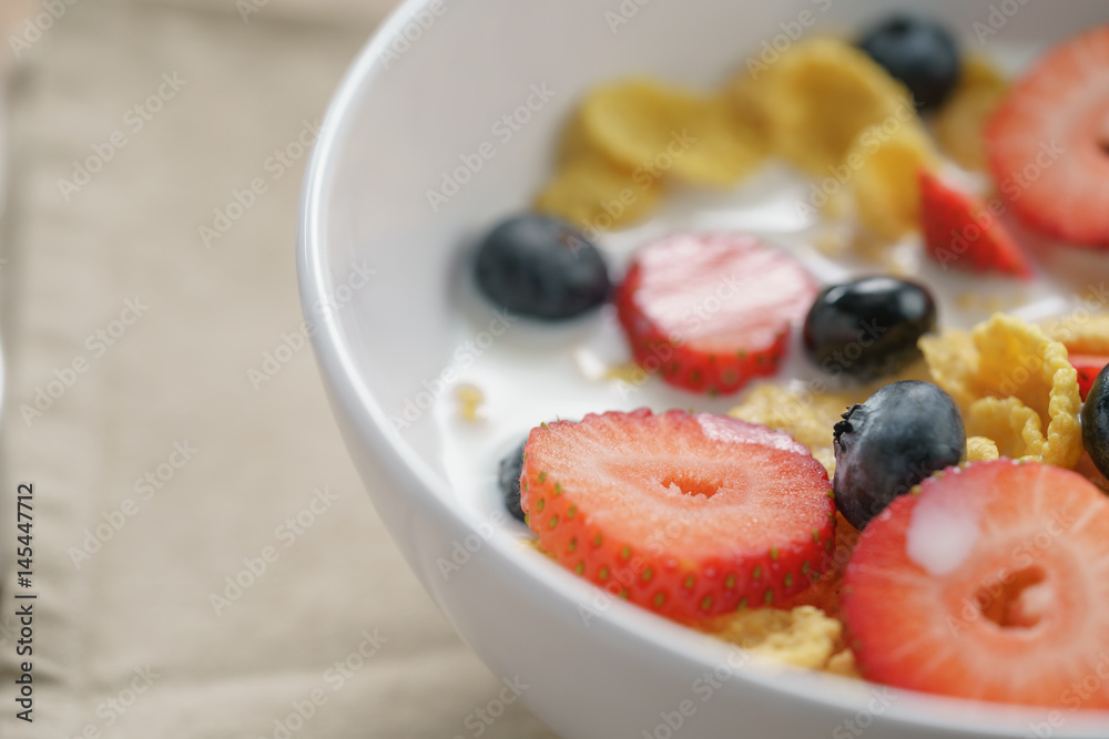 closeup of healthy breakfast with corn flakes and berries in white bowl, slightly toned photo closeup of healthy breakfast with corn flakes and berries in white bowl, slightly toned photo