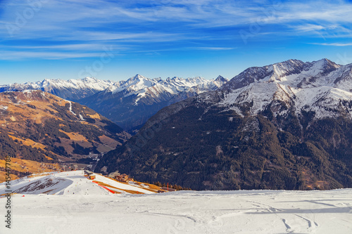 Ski resort in Mayrhofen, Austria, the Zillertal Valley. Beautiful mountain landscape. High mountains covered with snow. The ski slope descending downward.