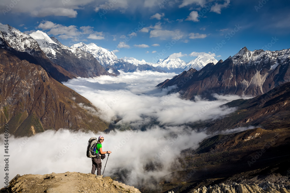 Trekker on the way to the valley covered with cloud on Manaslu circuit trek in Nepal