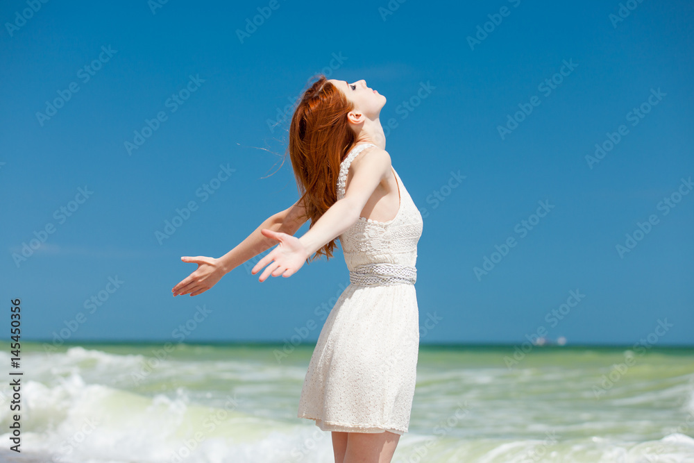 portrait of beautiful young woman standing on the coast and relaxing portrait of beautiful young woman standing on the coast and relaxing