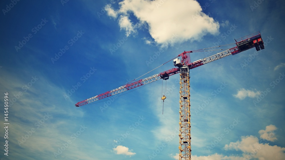Crane on construction with blue sky clouds and sun in the background. Crane on construction with blue sky clouds and sun in the background.