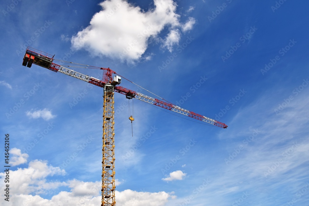 Crane on construction with blue sky clouds and sun in the background. Crane on construction with blue sky clouds and sun in the background.
