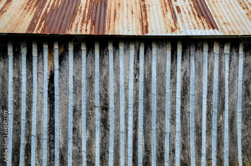 Old timber wall with rusty tin roof