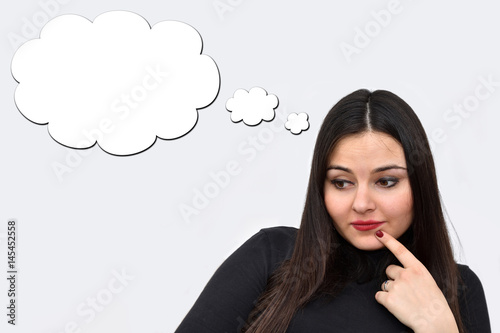 Thoughtful young woman with an empty thought bubble