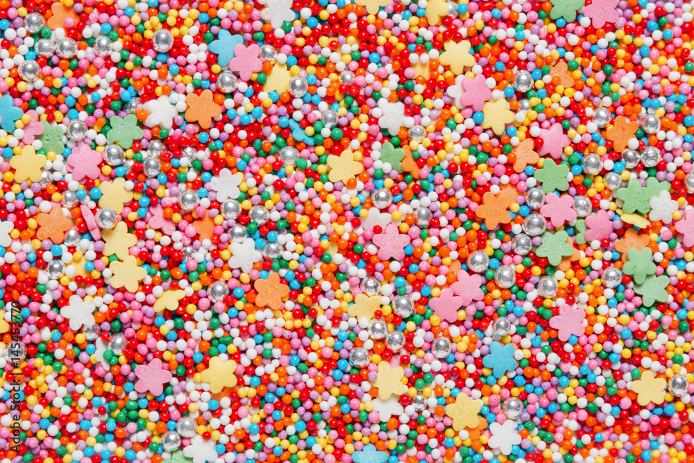 Colorful sweet background with sprinkles. Holiday treat. Cupcake and Ice cream topping. Sweet Texture. Sweet Background