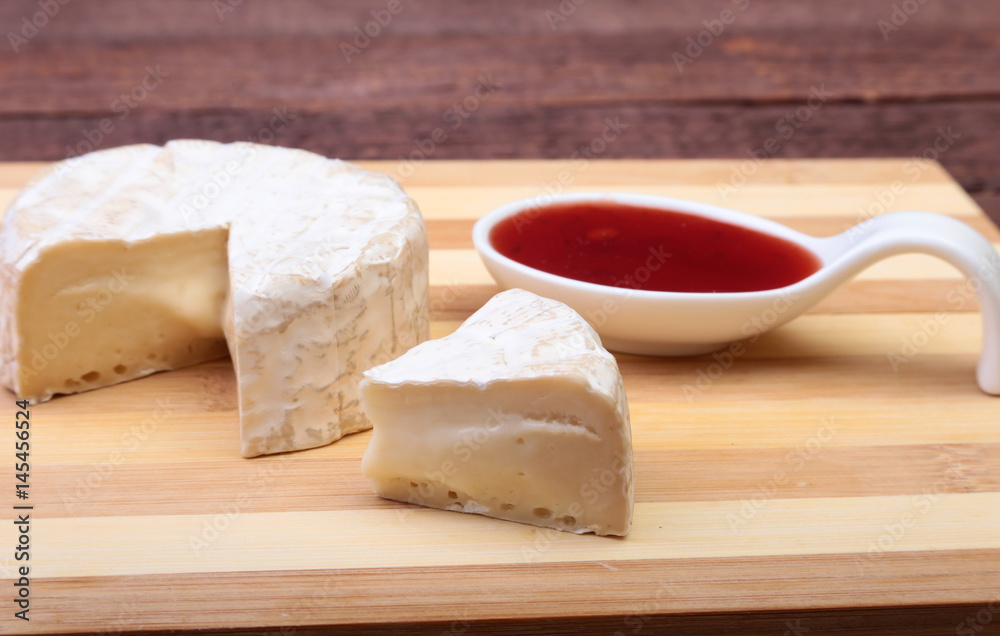 Cheese with white mold. Camembert or brie type with Cranberry sauce.. Healthy breakfast.