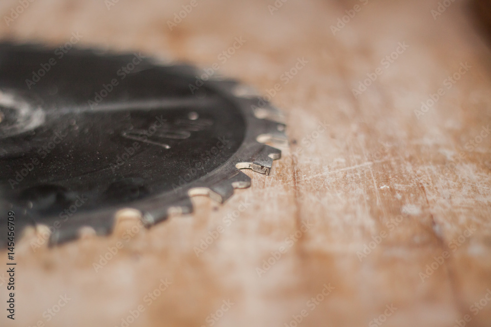 circular saw on wooden table macro picture