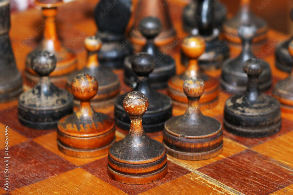 Old wooden chess on a chessboard, retro Old wooden chess on a chessboard, retro