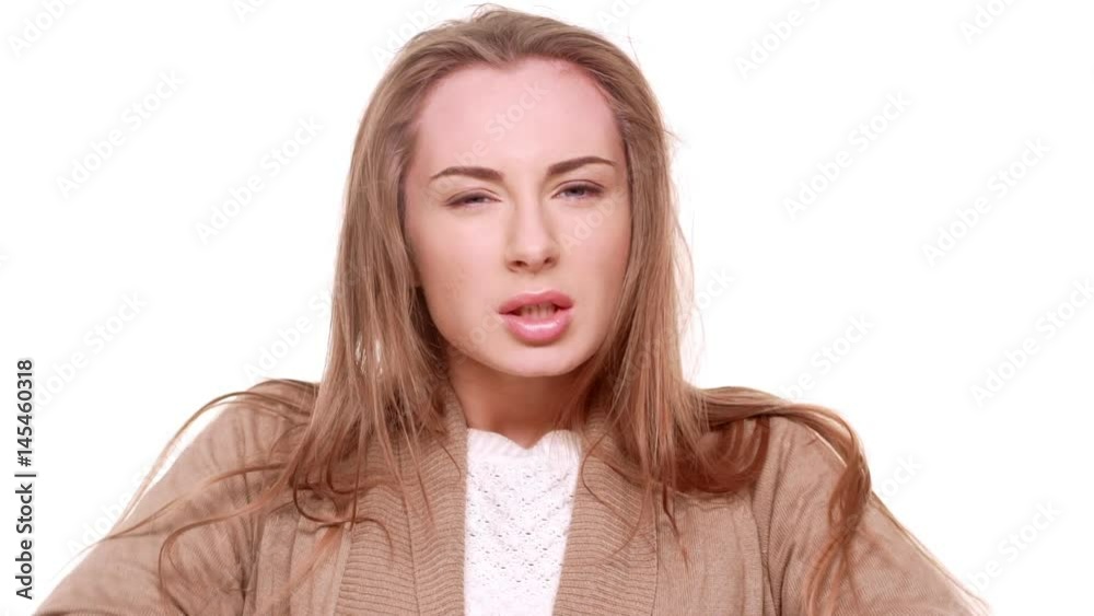 Furious Caucasian female standing trying to calm down standing on white background in slowmotion Furious Caucasian female standing trying to calm down standing on white background in slowmotion