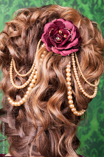 Beautiful hairstyle from behind on green background in retro interior. Rococo period. Luxury and high class
