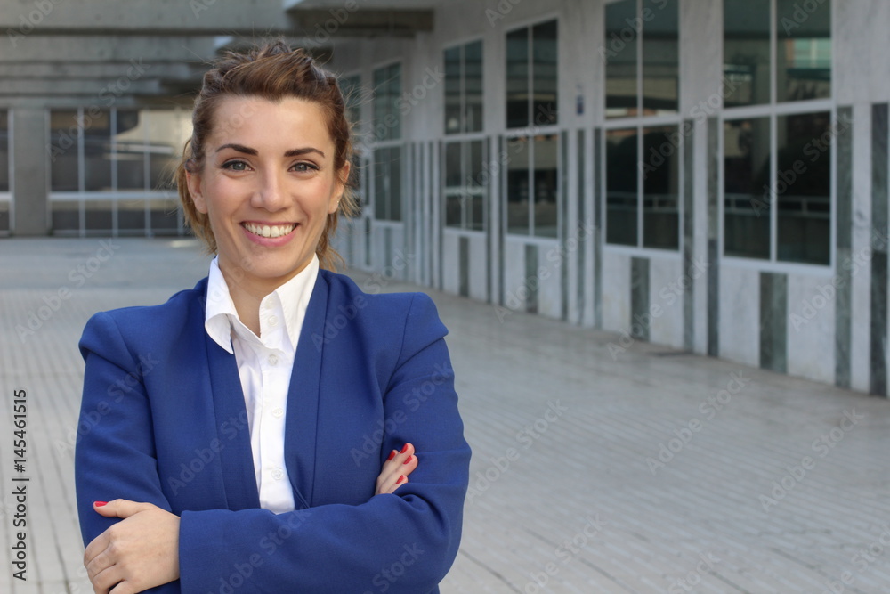Mid adult businesswoman smiling with arms crossed and copy space Mid adult businesswoman smiling with arms crossed and copy space