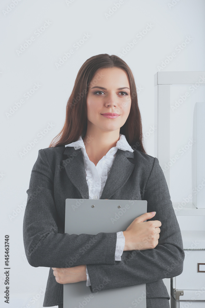 Portrait of business woman standing with folder Portrait of business woman standing with folder