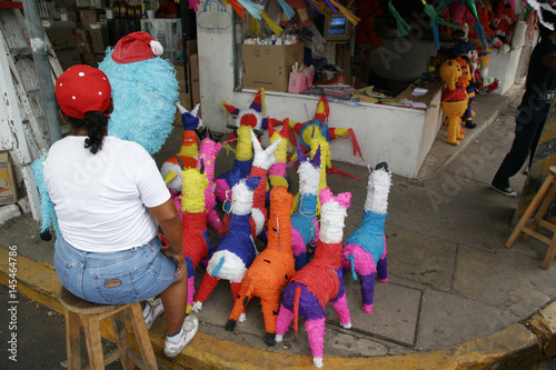 Woman selling Mexican piñatas outside the Villahermosa market, Tabasco, Mexico.
