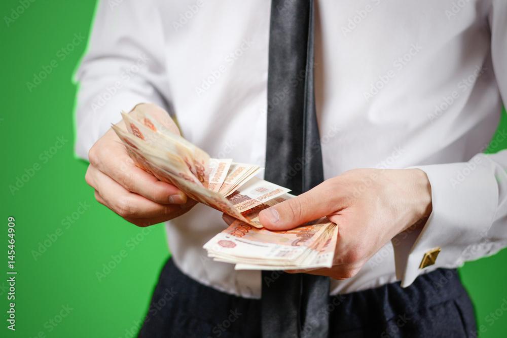 Obraz premium Closeup of businessman holds money. Banknotes Of Russia. Isolated