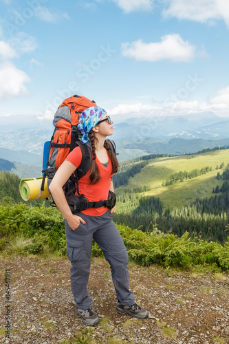 hiker relaxing on top of mountain