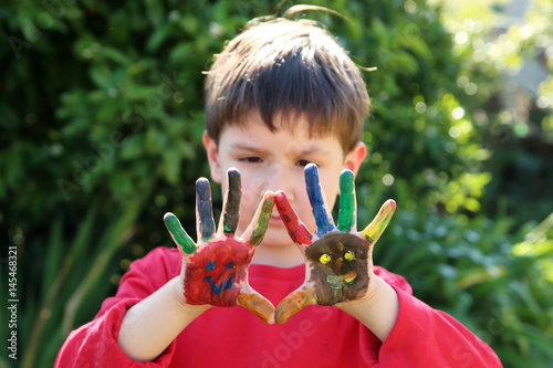 littlekid showing his painted had photo