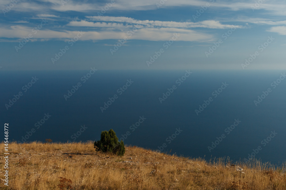 Blue sky with clouds and airplane trails over the Black sea. Nature composition in Crimea, Ukraine 2011.