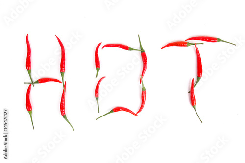 Word HOT by red chili pepper on white backgroun