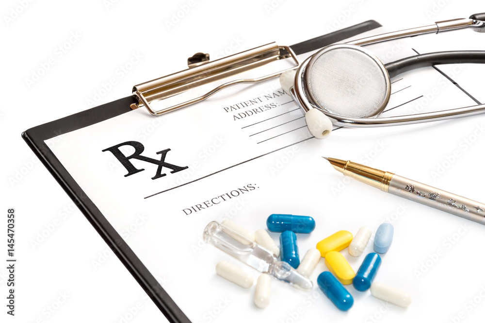 Prescription form on the clipboard with stethoscope and pills. Isolated on white. Medical concept.