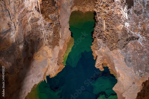 Underground lake sorrunded by rocks photo