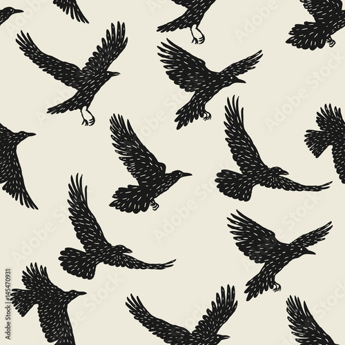 Seamless pattern with black flying ravens. Hand drawn inky birds