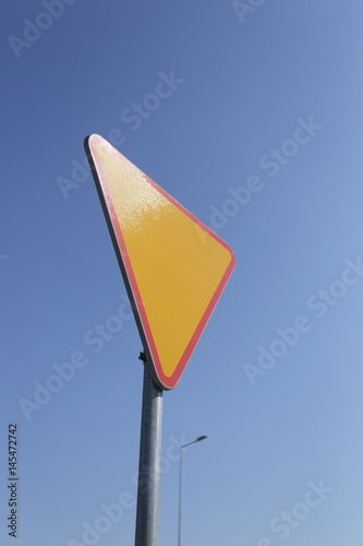 Give way yellow traffic sign.