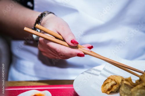 Hand holding chopsticks ready to eat. photo