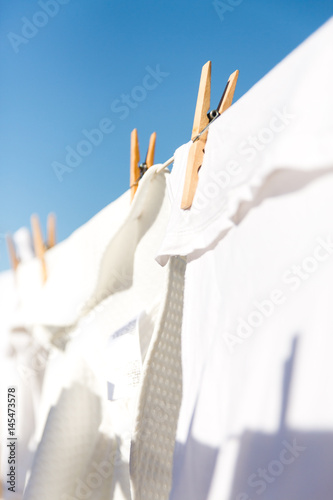 White clothes hung out to dry in the bright warm sun