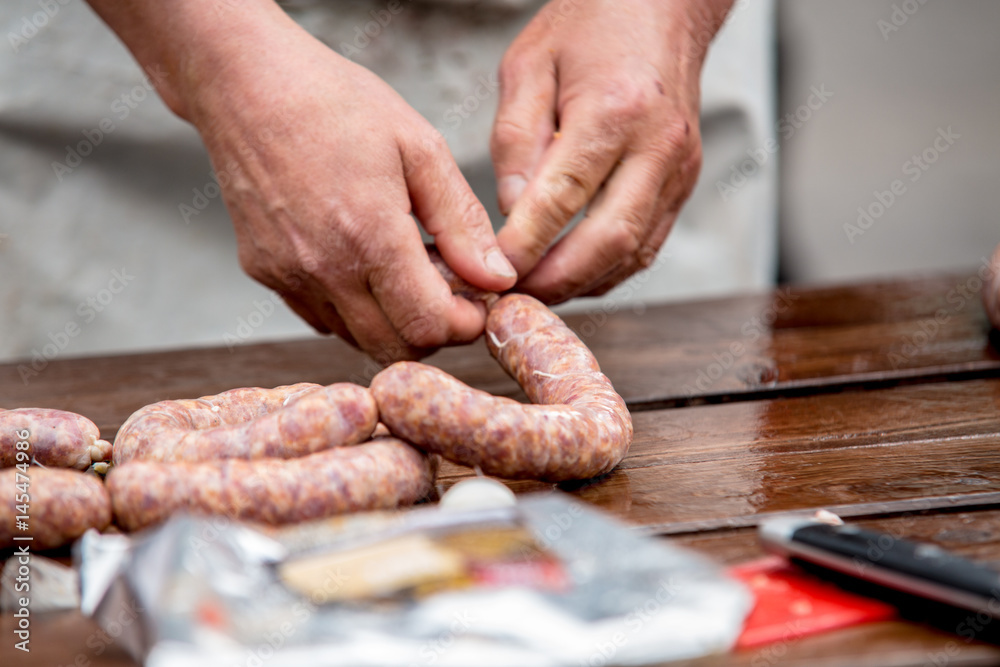 Butcher making sausages in meat factory Butcher making sausages in meat factory