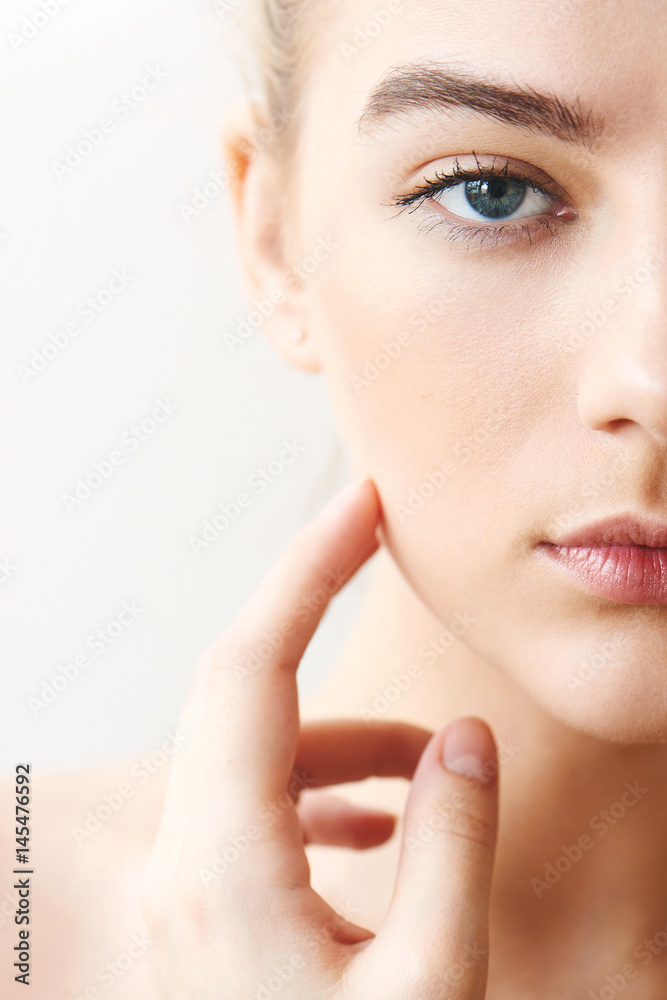Portrait of girl with make-up hand touching face closeup on white background Portrait of girl with make-up hand touching face closeup on white background