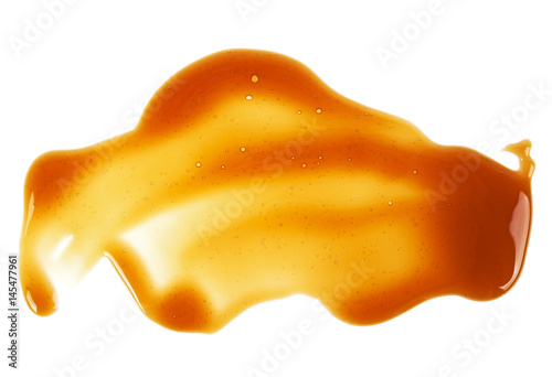 Sweet caramel sauce isolated on a white background, top view