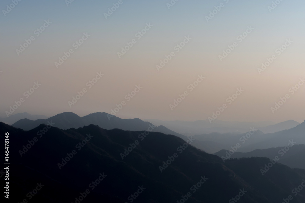 Landscape of nature mountain terrain hills layered in silhouette shade - with copy space