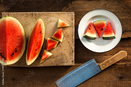 Sliced watermelon on wooden chopping board photo