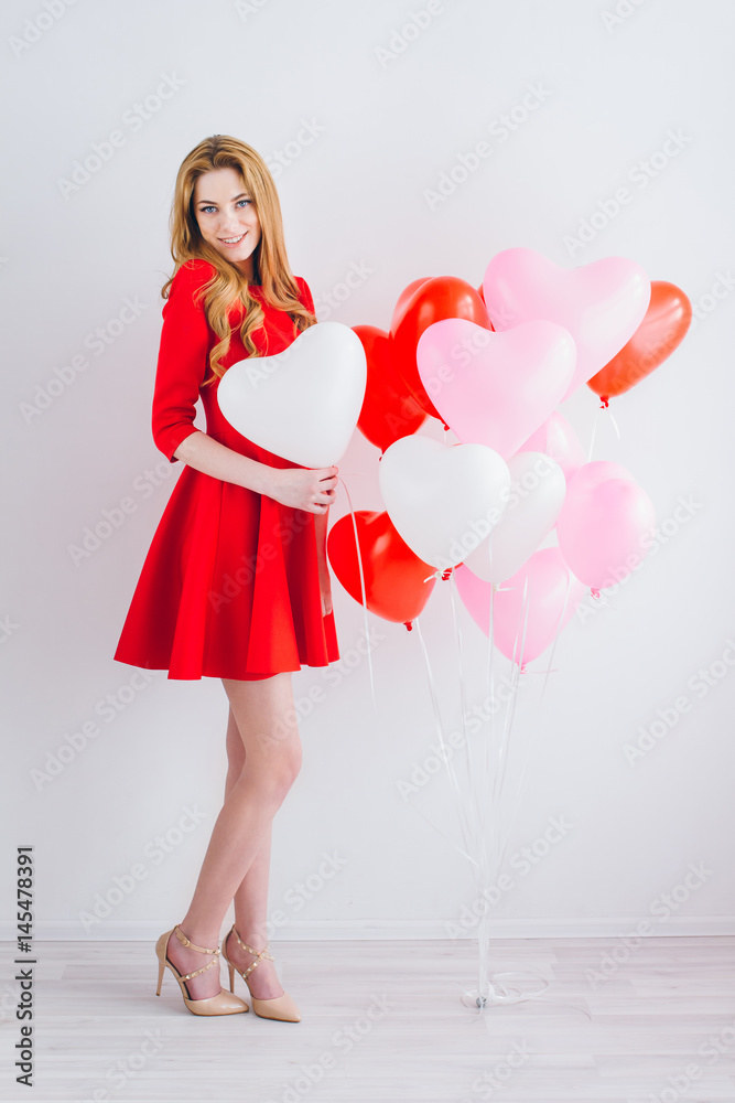 Girl in red dress with balloons in the shape of a heart Girl in red dress with balloons in the shape of a heart