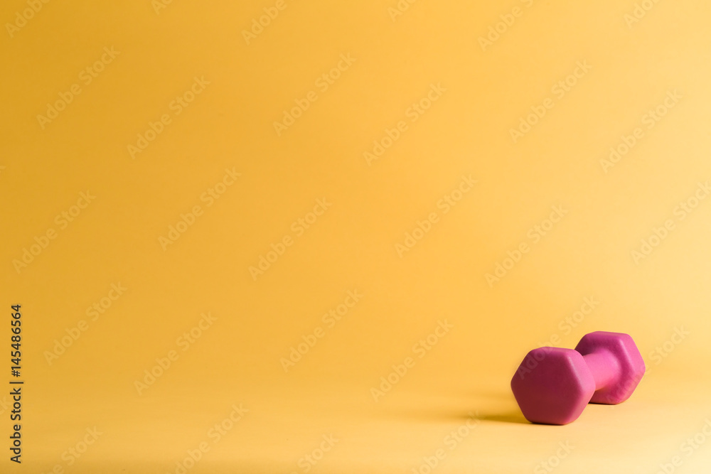 A single pink dumbbell A single pink dumbbell