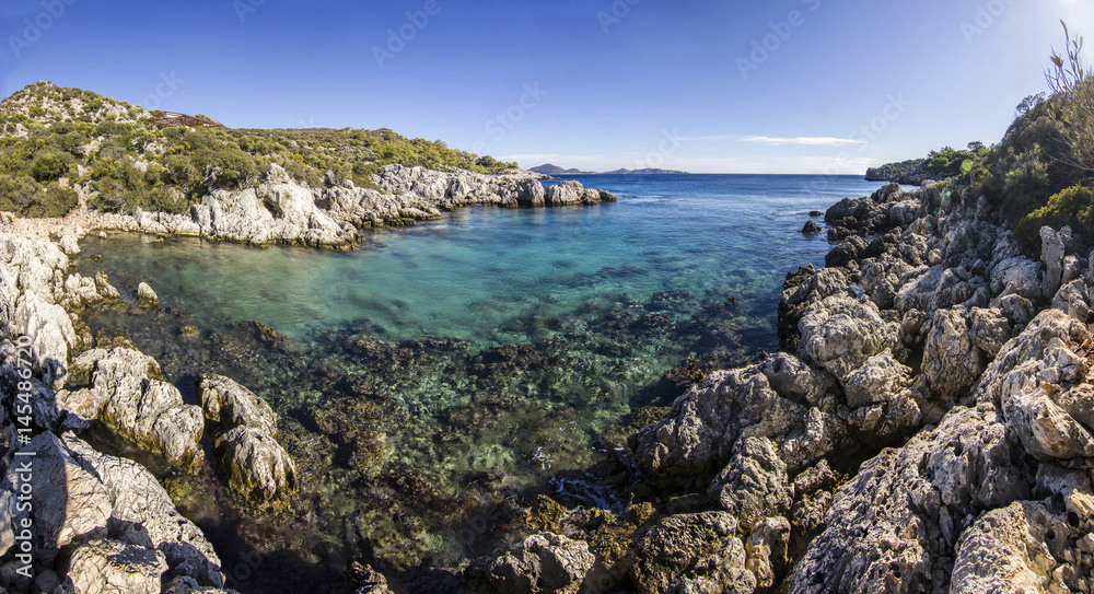 volcanic beach surrounded by mountains