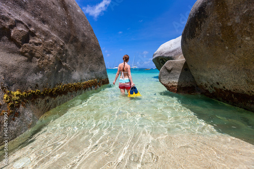 Woman with snorkeling equipment at tropical beach