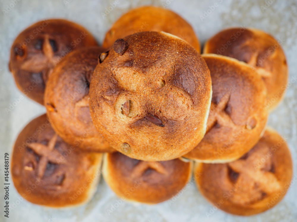 Fototapeta premium Pumpkin seed buns baked, in a pile on baking paper at close-up