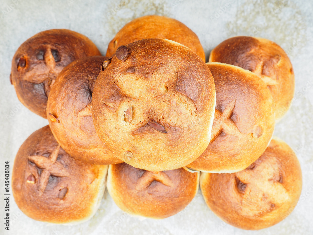 Fototapeta premium Pumpkin seed buns baked, in a pile on baking paper at close-up