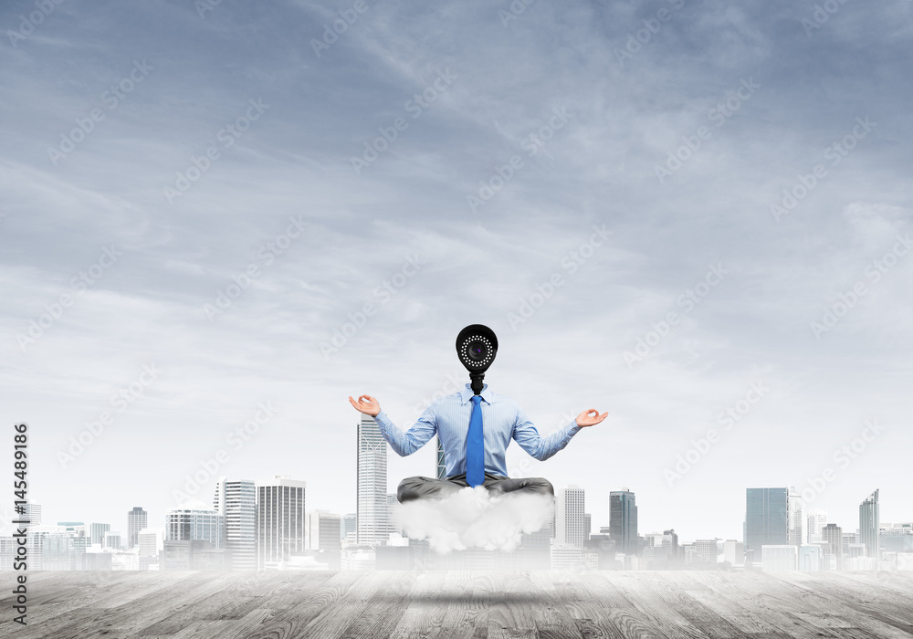 Camera headed man sitting in lotus pose on cloud against modern cityscape Camera headed man sitting in lotus pose on cloud against modern cityscape