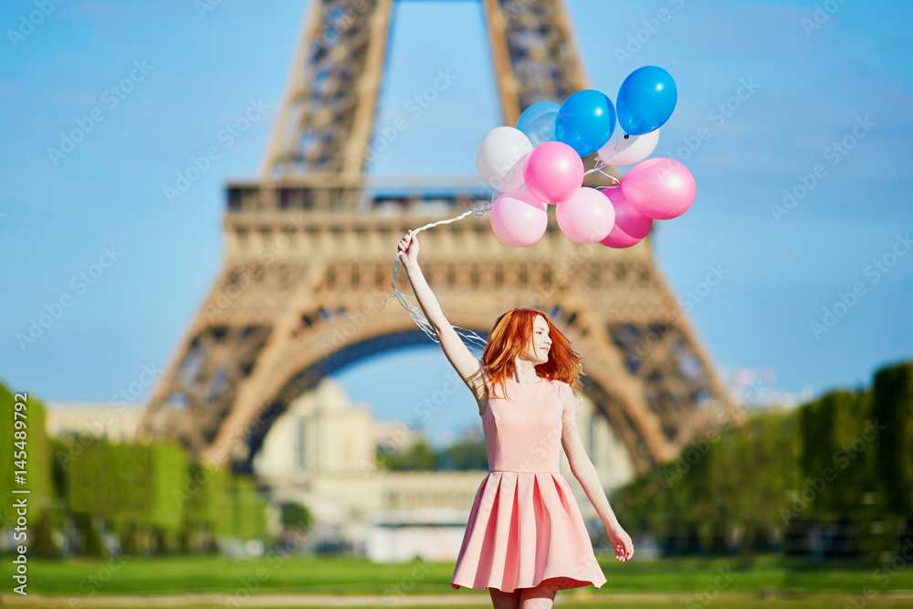 Woman in pink dress with bunch of balloons dancing near the Eiffel tower in  Paris, France Photos | Adobe Stock