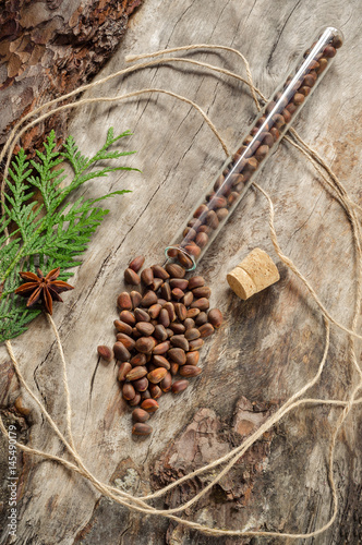 Unshelled pine nuts on aged wood photo