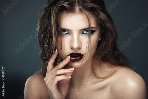 attractive young model with blue make-up and manicure