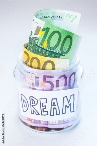 A jar with money and coins on white background isolated