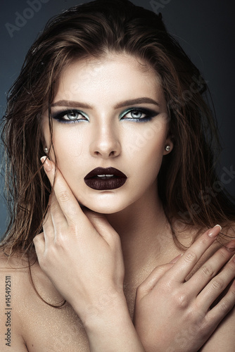 attractive young model with blue make-up and manicure